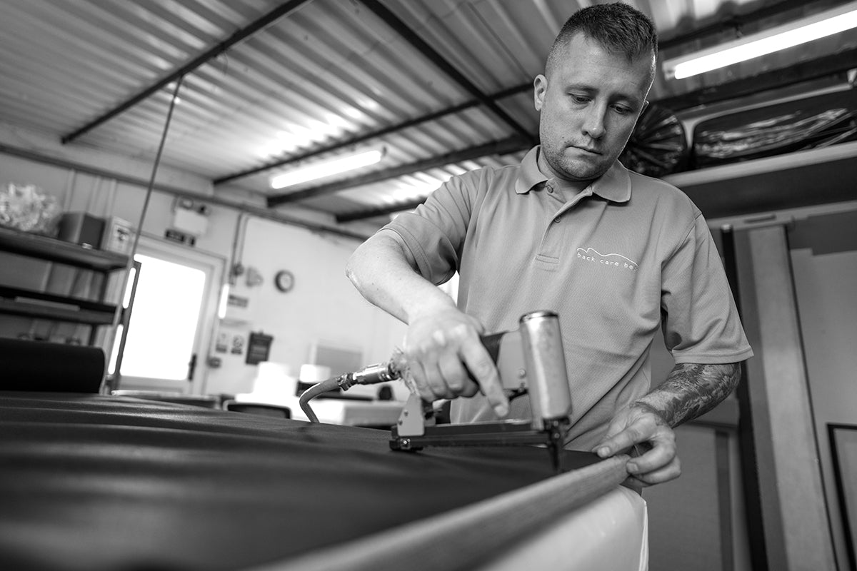 Person working on a headboard in a workshop