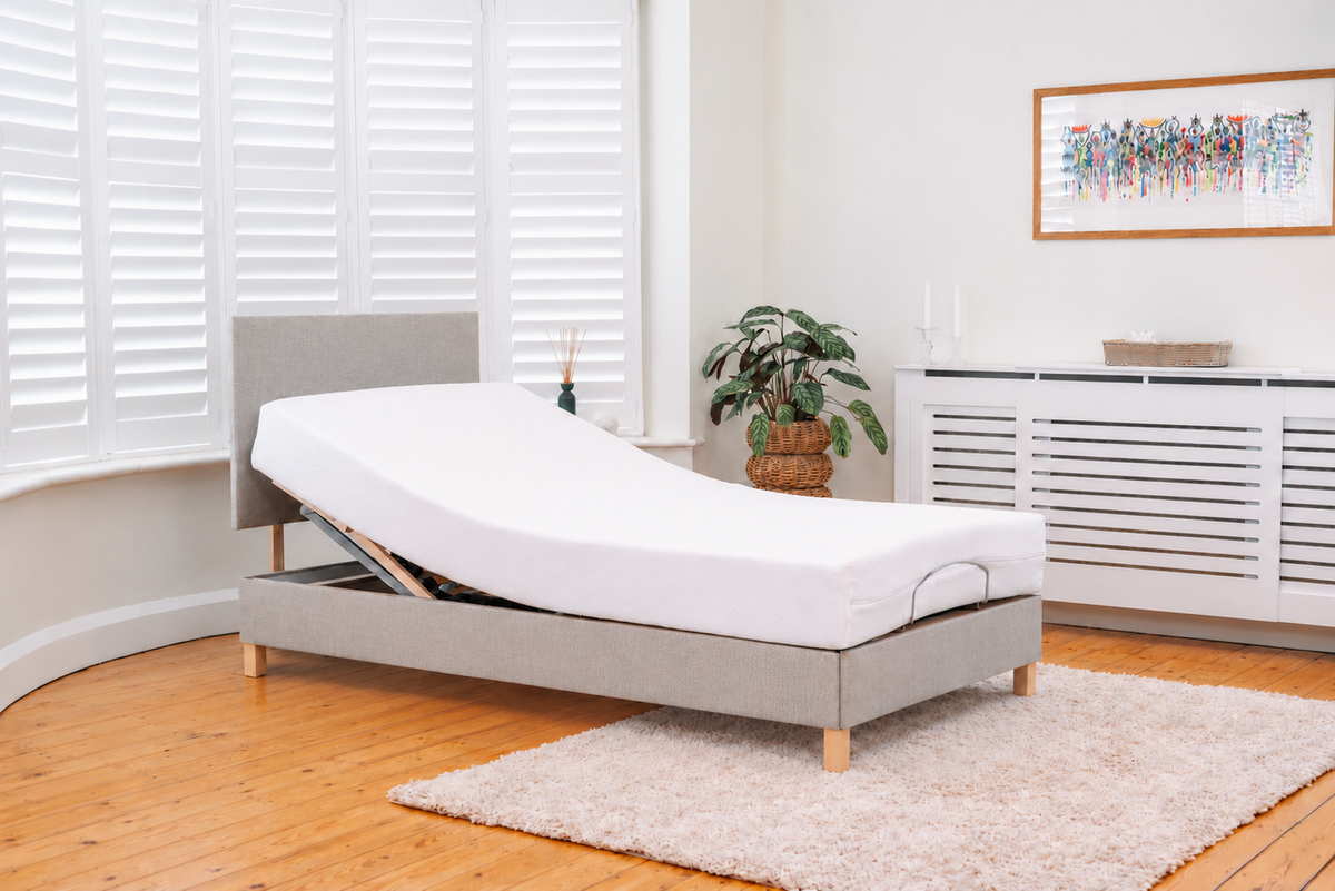 Simplicity adjustable bed in a white room with the head section raised