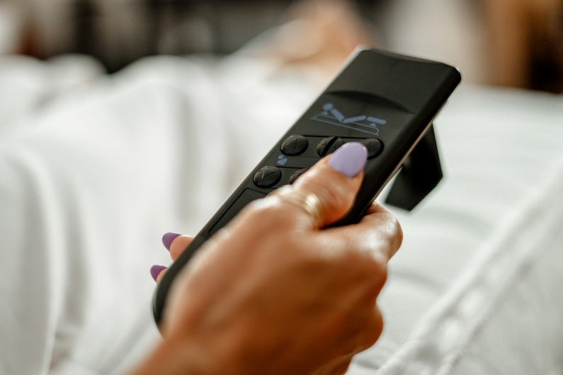 Person holding a remote control with a blurred background