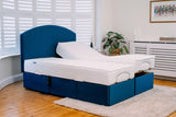 Blue adjustable bed frame with white mattress in a room with wooden floor and window blinds.